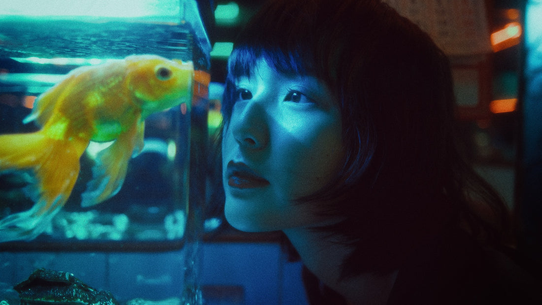 A woman looking at a fish inside an aquarium